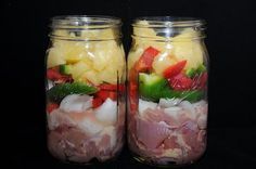 two mason jars filled with different types of food