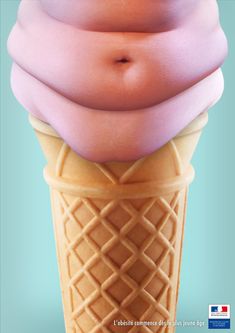 an ice cream cone with pink icing on it's top and the shape of a pregnant belly