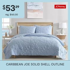 a bed with blue comforter and pillows on it for $ 53 99 reg $ 156 00