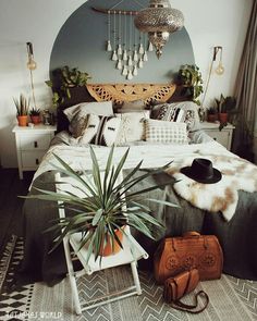 a bed room with a neatly made bed and plants