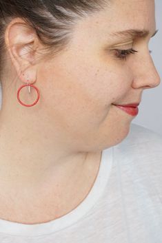 These lightweight circle earrings are sure to become your new favorite pair. An update on classic hoops, each circle retains evidence of their making - a small dot marks the spot where I hand-weld each earring. Approximately 1 1/4" tall (including ear wires) and 7/8" wide. Powder coated in a bright red color. Sterling silver ear wires. Handcrafted in my Pennsylvania studio. Ships in 1-2 business days. Comes in a gift box. Treat yourself or a loved one! Coral Red, Circle Earrings, Bright Red, Ear Wires, Powder Coated, Red Color, Pennsylvania, Dots, Coral