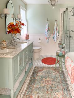 a bathroom with a rug, sink and shower