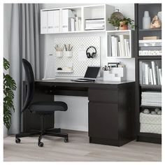 a black chair sitting in front of a desk