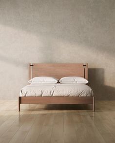 a bed sitting on top of a wooden floor next to a wall