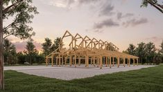 a large wooden structure sitting on top of a lush green field