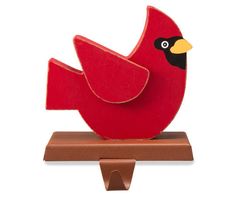 a red bird sitting on top of a wooden stand