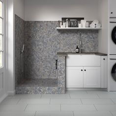 a washer and dryer in a room with tile flooring on the walls