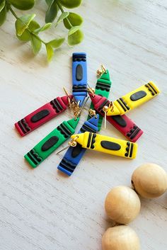 several different colored plastic objects sitting on top of a wooden table next to some nuts