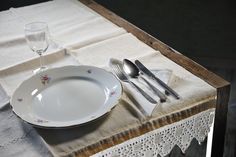 an empty plate and silverware on a table