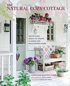 a magazine cover with flowers on the front porch and in the background is a white house