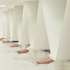 there are many people laying on the floor with their legs up and feet in the air