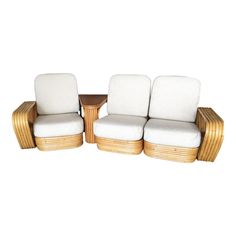 two chairs and a table with white cushions