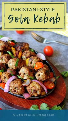 a plate filled with meatballs and vegetables on top of a wooden cutting board next to a