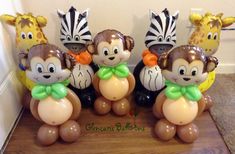 some very cute looking balloons in the shape of monkeys and giraffe's