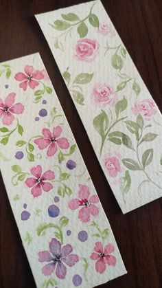 two pieces of paper with flowers painted on them