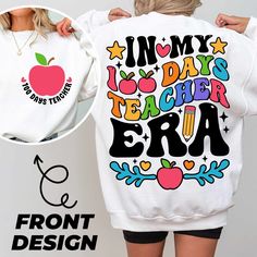 the back of a woman's sweatshirt with an image of an apple on it