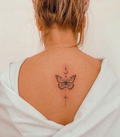 a woman with a butterfly tattoo on her back