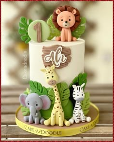 a birthday cake decorated with animals and leaves