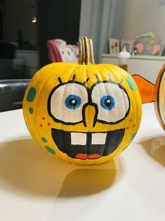 two pumpkins decorated to look like cartoon characters