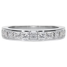 a white gold wedding band with princess cut diamonds on the sides and channel set shoulders