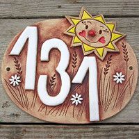 a wooden plaque with the number eighteen and sun above it on a wood plank background