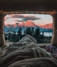 the view from inside an rv looking out at mountains and trees with lights on them