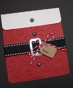 a red and black card with a tag on it