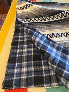 several different colored plaid fabric on a table