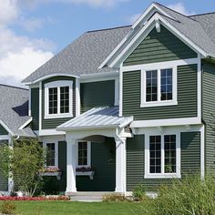 a green house with white trim and windows