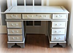 a white desk with lots of drawers on it