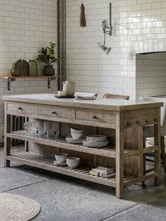 a kitchen island with plates and bowls on it