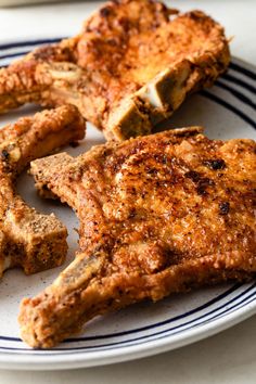 three pieces of meat on a plate with some dipping sauce in the middle and one piece cut out