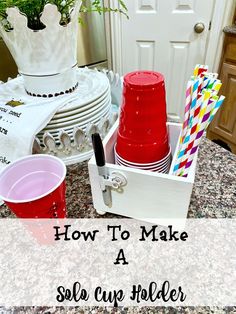 a pile of red cups sitting on top of a counter next to a stack of white plates