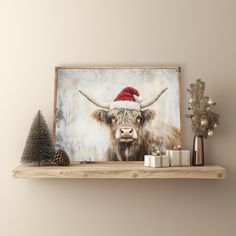 a painting of a bull wearing a santa hat on a shelf next to christmas decorations