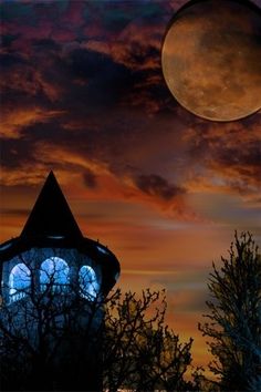 the moon is setting over a building with two windows