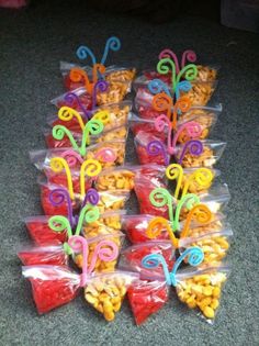 there are many bags of snacks in the shape of butterfly shaped candies on the floor