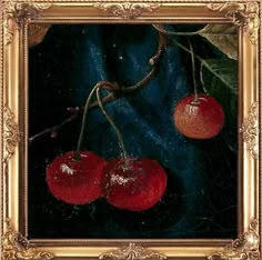 two cherries hanging from a branch in a gold framed painting on a black background