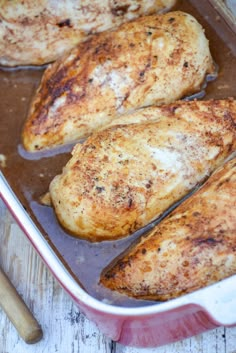 some chicken is cooking in a pan on the table