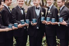 a group of men in tuxedos holding coffee mugs