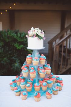 a cake and cupcakes are arranged on a table