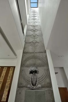 the floor is made up of concrete and has an intricate design on it, as well as a decorative umbrella