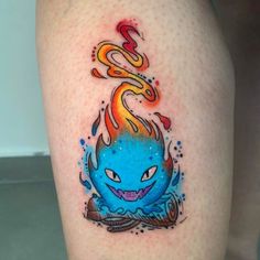 a tattoo on the leg of a person with a blue and orange flame coming out of it