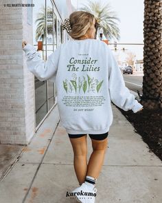 This Unisex crewneck sweatshirt features "Luke 12:26-28 | Consider The Lilies | Do Not Worry" with dainty hand-drawn Lily of the valley illustrations on the back and front pocket side. Spread God's faithfulness and the gospel with this Christian sweater <3 Make sure to check out the other garment options below :) » O P T I O N S « ‣ Tshirt: https://www.etsy.com/listing/1685275390 ‣ Hoodie: https://www.etsy.com/listing/1733221410 » A B O U T « ‣ This item is made to order using direct-to-garment Spring Lettering Sweatshirt Relaxed Fit, Relaxed Fit Lettering Sweatshirt For Spring, Relaxed Fit Sweatshirt With Lettering For Spring, Lilies Bible Verse, Christian Sweater, Consider The Lilies, Christian Sweaters, Christian Clothes, Faith Based Clothing