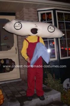 a man dressed as a cartoon character standing in front of a house