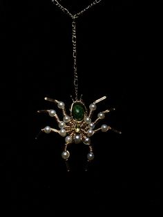 Step into the extraordinary with this breathtakingly unique spider necklace, a masterpiece of craftsmanship and nature's rare beauty. The spider's body is sculpted from 14/20k gold-filled wire, its legs adorned with 17 luminous pearl-colored beads that catch the light with every movement. A single bead graces its mouth, adding an ethereal touch of life to this enchanting creature. At the heart of this design is an exceptionally rare Isle Royale greenstone, an exquisite specimen with its signature chlorastrolite pattern--a true treasure of the natural world. Complementing this striking body is a 3mm vibrant peridot, gleaming brilliantly as the spider's head. This necklace is not just jewelry; it is a wearable work of art, entirely one-of-a-kind and made with care and precision. A perfect st Isle Royale, Spider Pendant, Spider Design, Spider Jewelry, Spider Necklace, Smart Auto, Single Bead, Rare Beauty, The Natural World