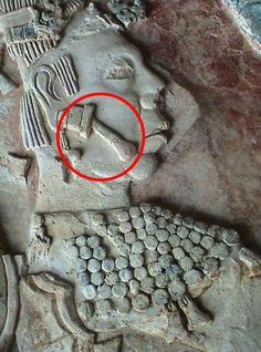 a red circle is in the middle of an ancient relief with images of people and animals on it