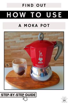 a red coffee pot sitting on top of a wooden tray