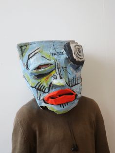 a person wearing a blue mask with red lipstick on it's lips and nose