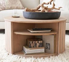 a coffee table with books and a bowl on top