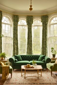 a living room filled with furniture and large windows covered in green drapes on top of them